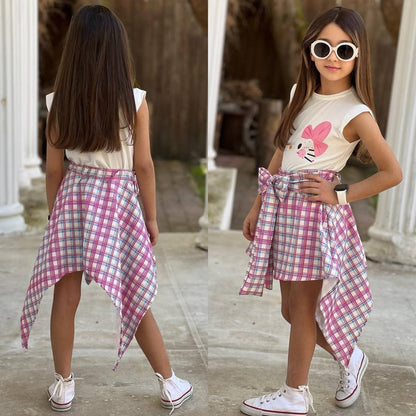 The Nile Luxuries girls white sleeveless top with pink bow graphic and pink plaid handkerchief hem skirt with tie waist.