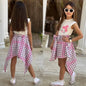 The Nile Luxuries girls white sleeveless top with pink bow graphic and pink plaid handkerchief hem skirt with tie waist.