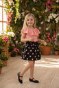 The Nile Luxuries girls' pink ruffled top and black polka dot skirt set with bow detail. Comfortable fabric.