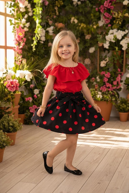 The Nile Luxuries girls' red ruffled top with black polka dot skirt and bow detail. Comfortable fabric for all-day wear.