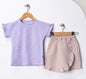 The Nile Luxuries girls' lavender cotton t-shirt with ruffled sleeves and a beige wrap skirt with ruffled trim.