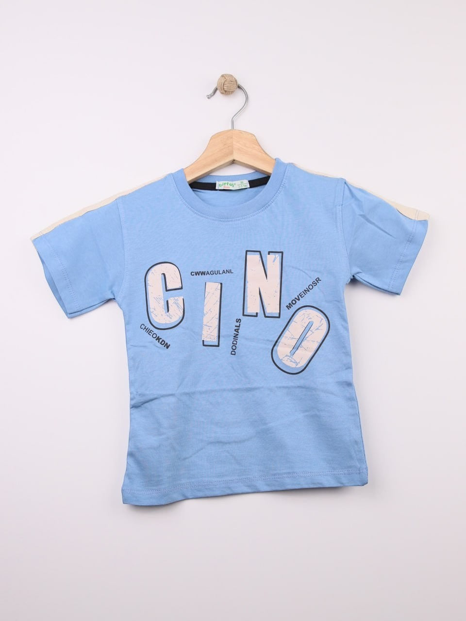 The Nile Luxuries light blue cotton t-shirt for kids with a graphic print featuring large letters and abstract design.