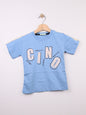 The Nile Luxuries light blue cotton t-shirt for kids with a graphic print featuring large letters and abstract design.
