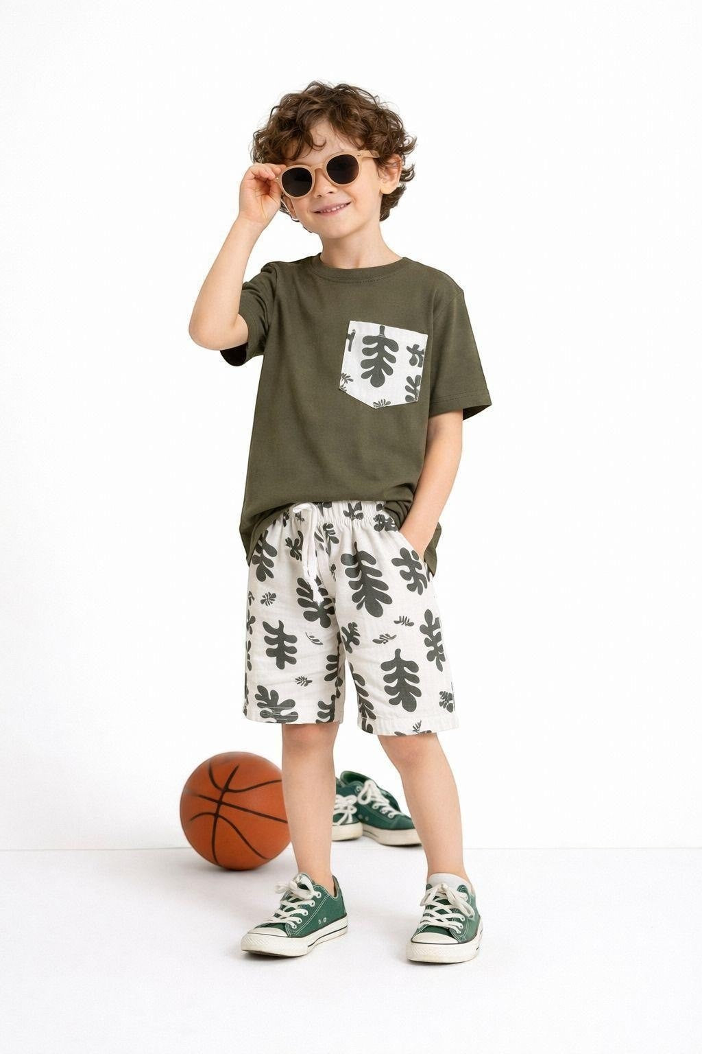 The Nile Luxuries boys' olive green t-shirt with leaf print pocket and matching leaf print shorts.