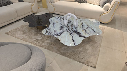 The Nile Luxuries modern coffee table set with organic marble-effect tops in black, white, and gold on black metal legs.