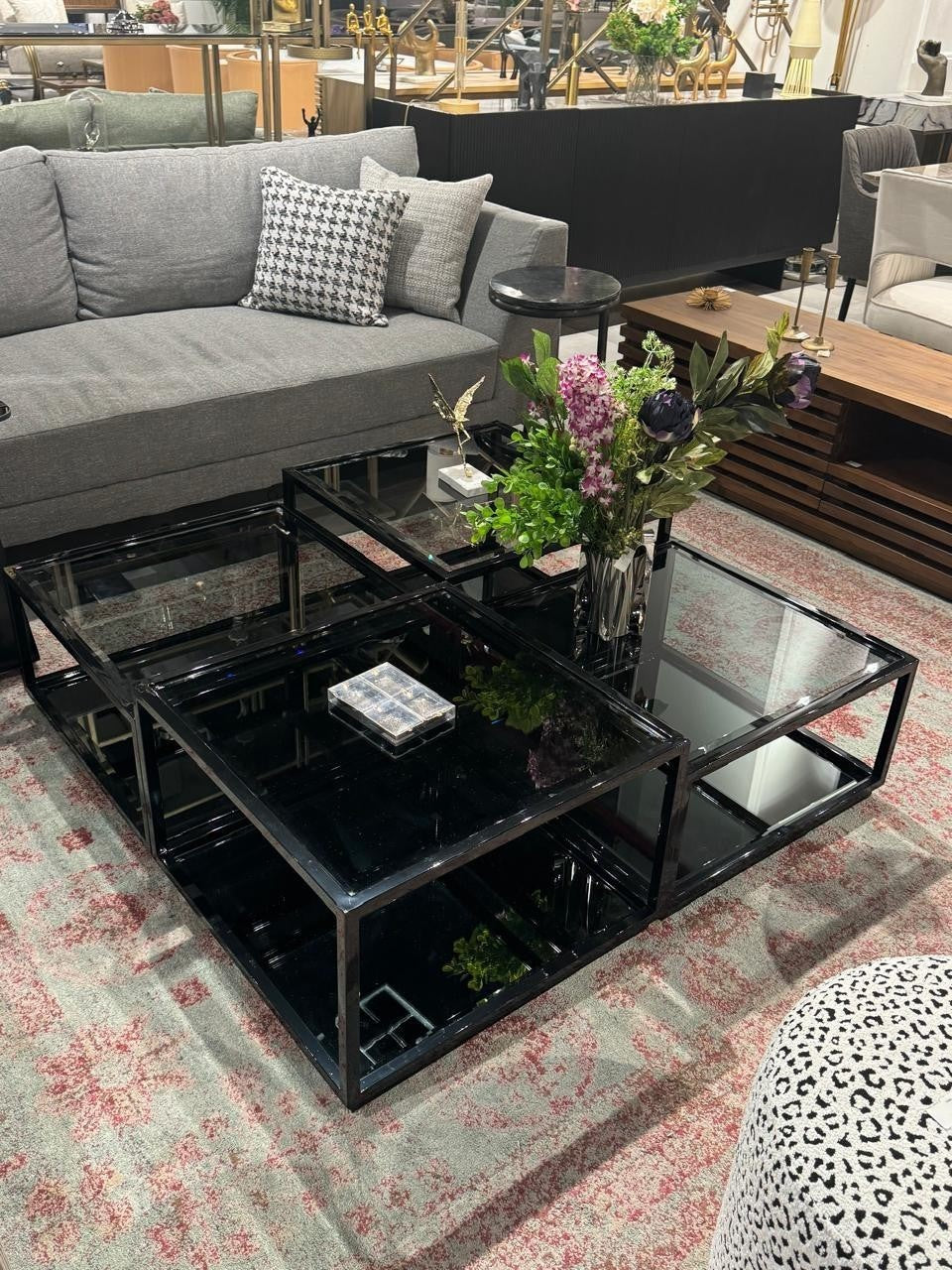 The Nile Luxuries modern modular coffee table with black frame and mirrored surfaces. Features geometric silhouette and reflective surfaces.