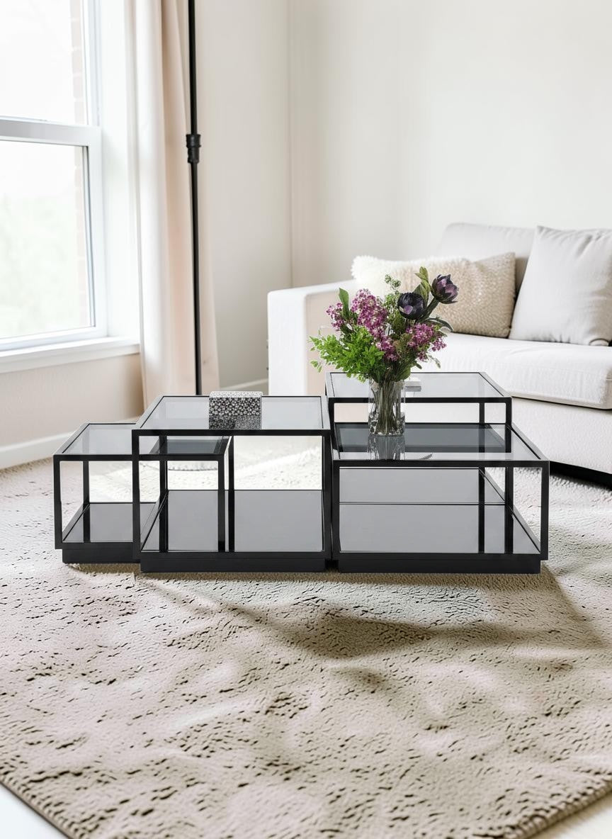 The Nile Luxuries modular coffee table with black frame and mirrored surfaces, featuring a contemporary geometric design.
