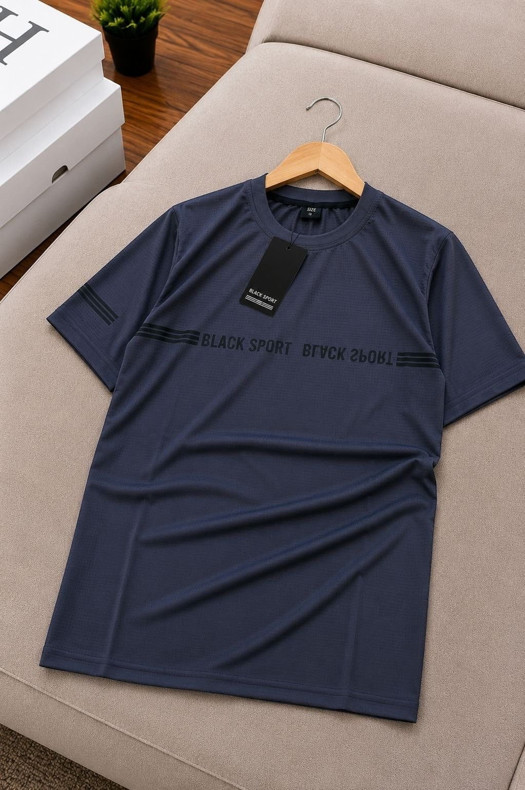 The Nile Luxuries navy blue athletic t-shirt with crew neck, short sleeves, and black graphic text detail.