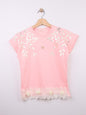 The Nile Luxuries pink cotton t-shirt with metallic leaf print, gold heart emblem, and ruffled hem with fabric roses.