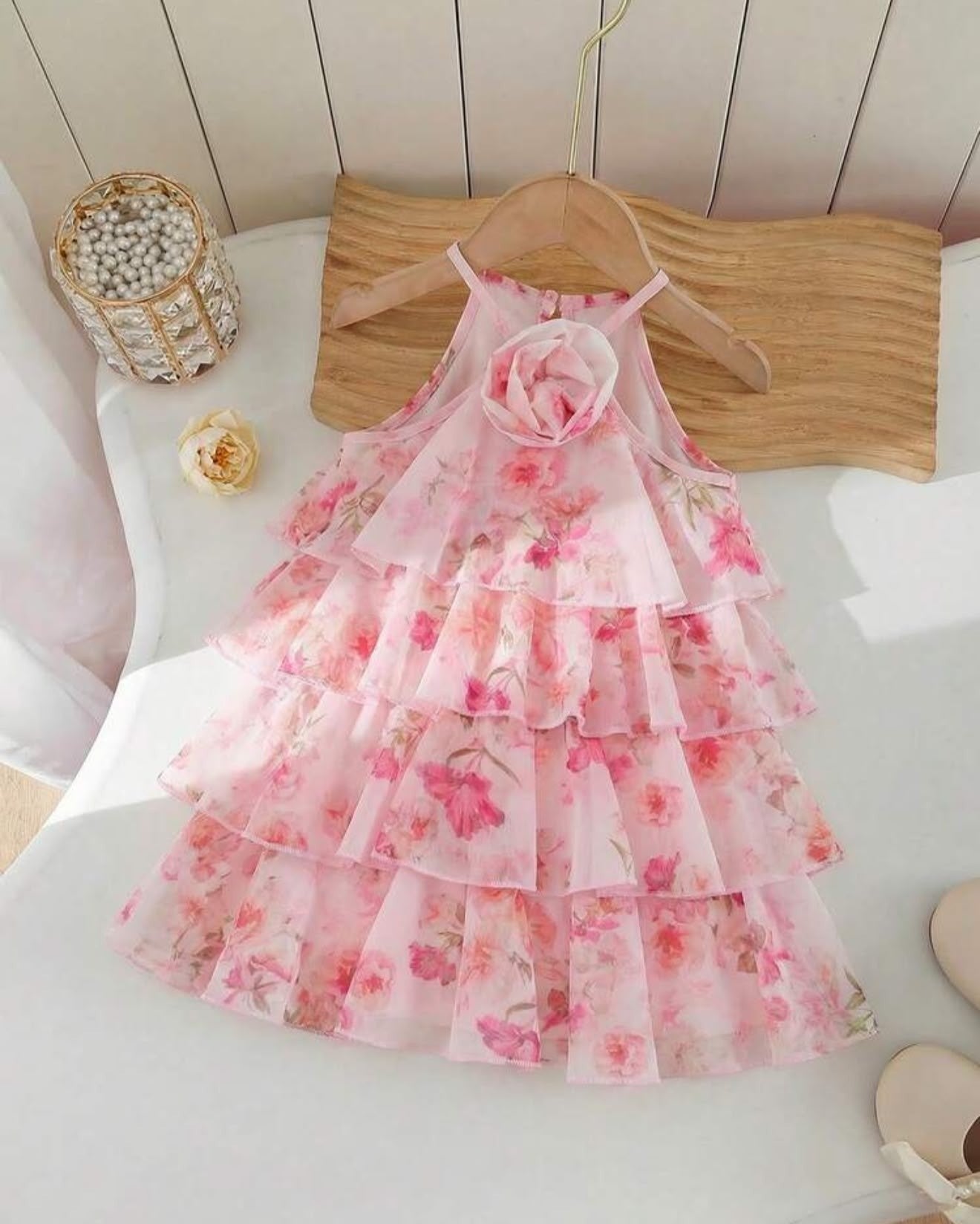The Nile Luxuries girls' pink floral chiffon tiered ruffle halter neck dress with fabric flower accent.