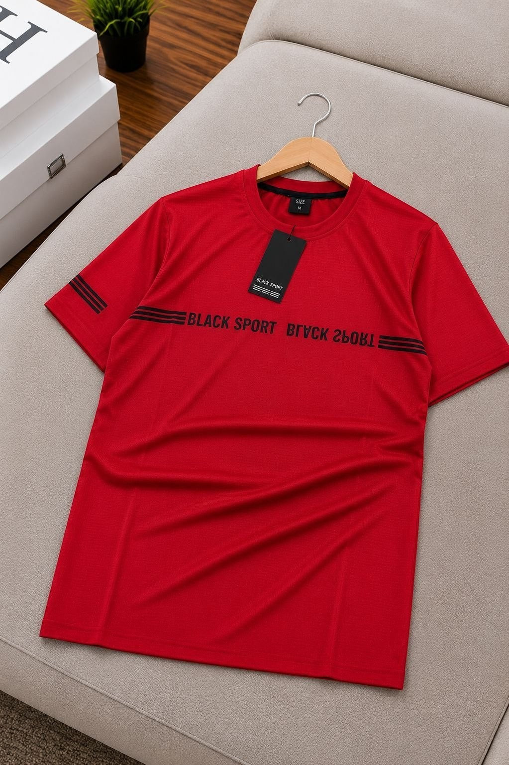 The Nile Luxuries red athletic t-shirt with black graphic print on chest and sleeves, crew neck, short sleeves.