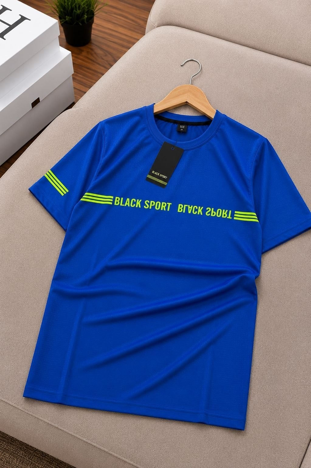 The Nile Luxuries royal blue athletic t-shirt with neon green graphic print on chest and sleeves.