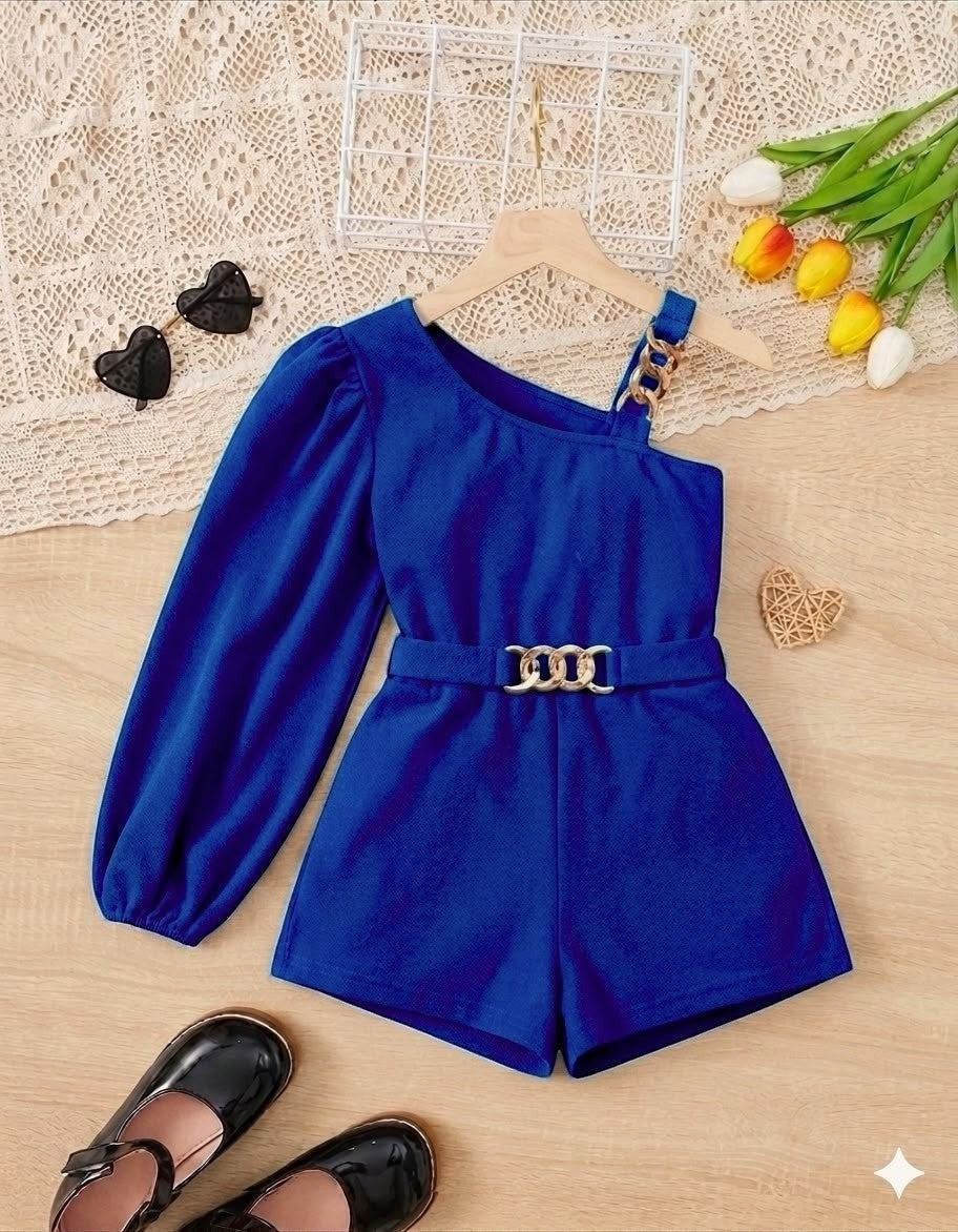 The Nile Luxuries royal blue one-shoulder romper with puff sleeve, gold chain belt, and shorts.