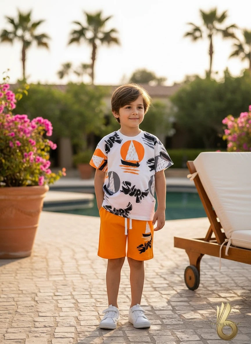 The Nile Luxuries white cotton t-shirt with sailboat graphic and orange shorts set for boys.