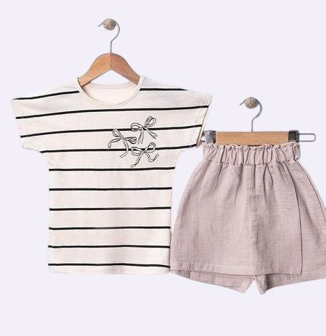 The Nile Luxuries striped t-shirt with bow detail and matching blush pink shorts. Cotton set for kids.