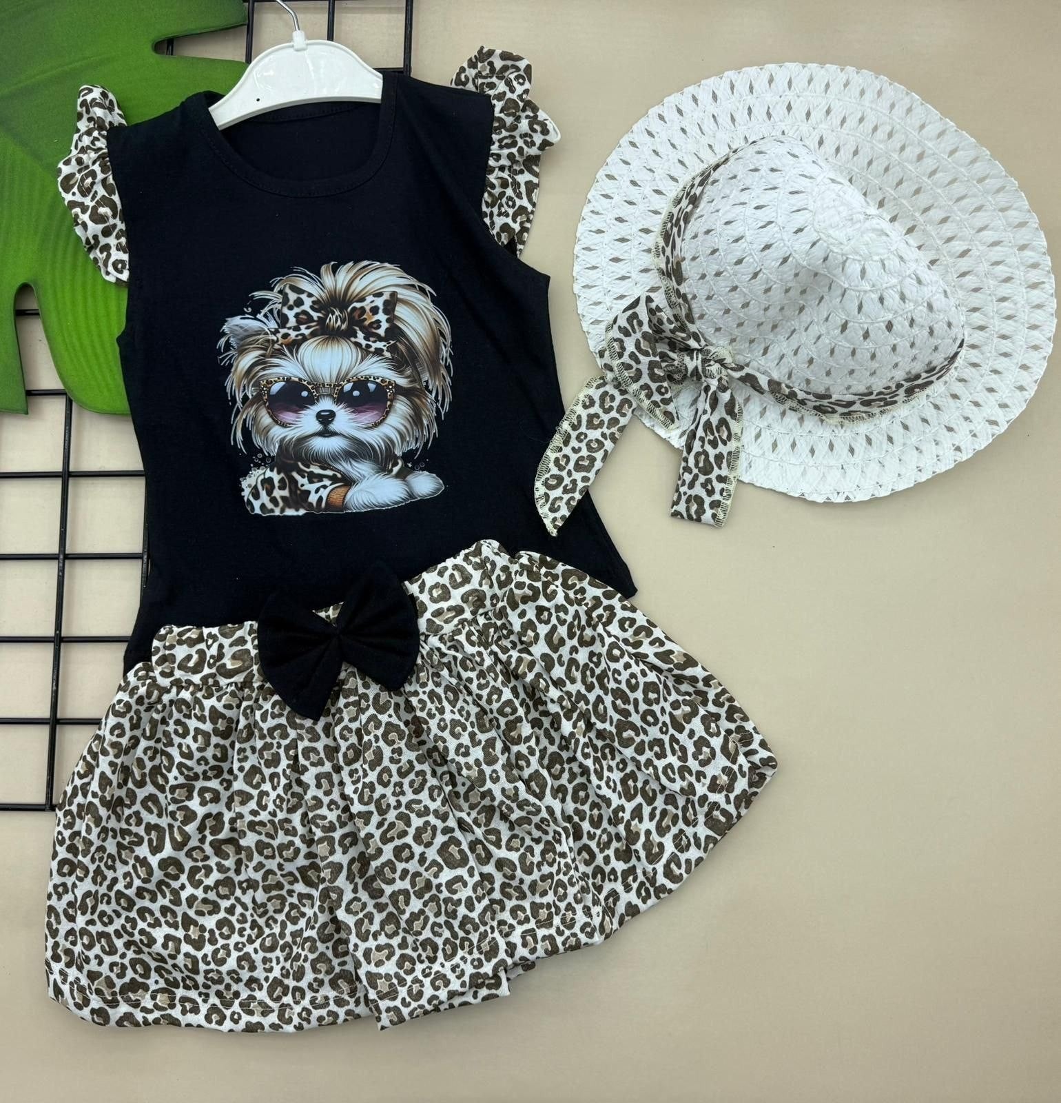 The Nile Luxuries toddler girl's black sleeveless top with dog graphic, leopard print skirt, and white hat. Cotton.