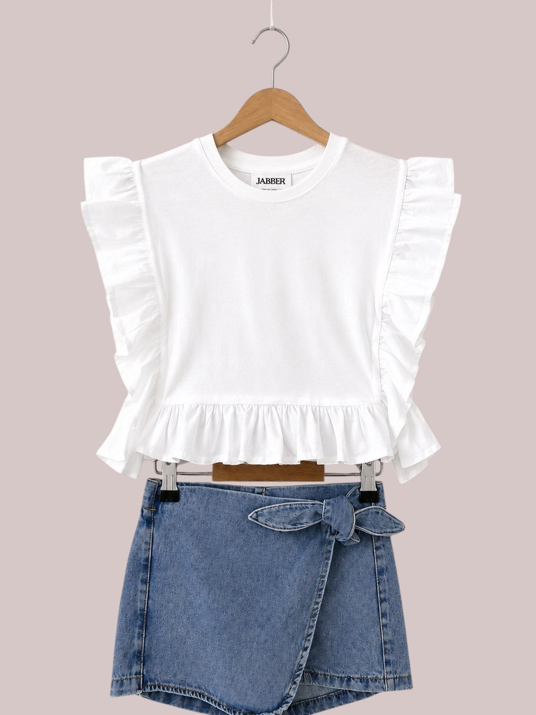 The Nile Luxuries white cotton peplum top with ruffled sleeves and denim wrap skirt with tie waist.