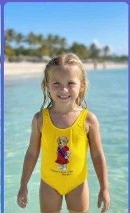 The Nile Luxuries yellow one-piece swimsuit for girls with graphic bear design. Comfortable fit for active play.